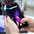 A person holding a Samsung smartphone with a close-up view of the display featuring a butterfly design. A person holding a Samsung smartphone with a close-up view of the display featuring a butterfly design.