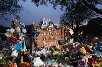 Memorial setup at Robb Elementary School featuring flowers, toys, and heartfelt tributes in remembrance of the victims of the May 2022 shooting.