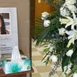 Memorial display for Cheyenna Costello, featuring a framed photo, flowers, and a tissue box. Memorial display for Cheyenna Costello, featuring a framed photo, flowers, and a tissue box.