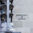 Signage of the Department of Justice on a building exterior. Signage of the Department of Justice on a building exterior.