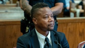Cuba Gooding, Jr. seated in a courtroom during a legal proceeding.
