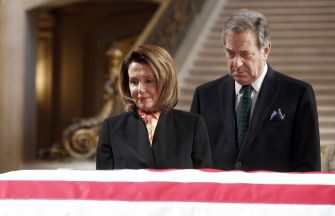 Nancy Pelosi and Paul Pelosi somberly pay their respects at a ceremony.