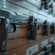 A display of handguns arranged on a wall in a gun shop. A display of handguns arranged on a wall in a gun shop.