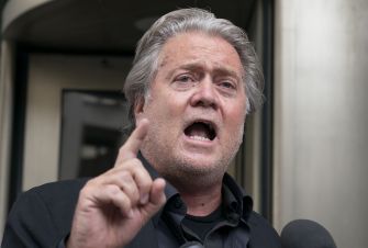 Steve Bannon speaking passionately to the media outside a courthouse.