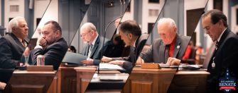 Delaware Senate members discussing legislation in session, reflecting on the recent deadlock over the doctor-assisted suicide bill.