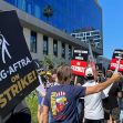 Protesters holding signs that read "SAG-AFTRA on STRIKE!" during a demonstration in support of the actors' union strike. Protesters holding signs that read "SAG-AFTRA on STRIKE!" during a demonstration in support of the actors' union strike.