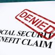 A document with the text "SOCIAL SECURITY BENEFIT CLAIM" and a red "DENIED" stamp across it. A document with the text "SOCIAL SECURITY BENEFIT CLAIM" and a red "DENIED" stamp across it.