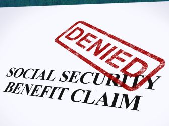 A document with the text "SOCIAL SECURITY BENEFIT CLAIM" and a red "DENIED" stamp across it.