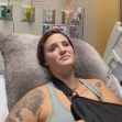 In a hospital bed, a protester with an arm sling and visible tattoos appears to be recovering from injuries sustained during a Black Lives Matter demonstration. In a hospital bed, a protester with an arm sling and visible tattoos appears to be recovering from injuries sustained during a Black Lives Matter demonstration.