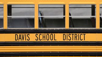 Image of a yellow school bus with the words "Davis School District" displayed on the side.