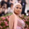 Nicki Minaj at a red carpet event, wearing a pink outfit with long, light pink hair. Nicki Minaj at a red carpet event, wearing a pink outfit with long, light pink hair.
