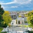 A scenic view of a university campus with greenery and buildings under a bright sky. A scenic view of a university campus with greenery and buildings under a bright sky.