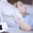 Close-up of a breathing machine next to a person asleep in bed. Close-up of a breathing machine next to a person asleep in bed.