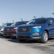 Row of Ford SUVs parked at a dealership. Row of Ford SUVs parked at a dealership.