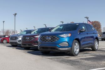 Row of Ford SUVs parked at a dealership.