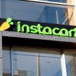 Instacart storefront sign displaying the logo with a stylized carrot and the company's name in green letters. Instacart storefront sign displaying the logo with a stylized carrot and the company's name in green letters.