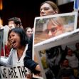 Families of Boeing crash victims hold photos and signs during a protest, urging the Department of Justice to impose a significant fine on the company. Families of Boeing crash victims hold photos and signs during a protest, urging the Department of Justice to impose a significant fine on the company.