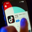 A close-up of a smartphone displaying the TikTok app, highlighting its logo and features. A close-up of a smartphone displaying the TikTok app, highlighting its logo and features.
