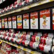 Canned soup displayed in gravity-fed racks at a grocery store. Canned soup displayed in gravity-fed racks at a grocery store.