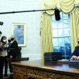 President Biden sitting at a desk in the Oval Office, surrounded by reporters as he prepares to sign executive orders. President Biden sitting at a desk in the Oval Office, surrounded by reporters as he prepares to sign executive orders.