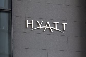 Signage of the Hyatt hotel chain on a building exterior.