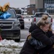 Two young girls embrace in front of a memorial at Oxford High School, surrounded by flowers and balloons, as the community mourns the aftermath of a recent school shooting. Two young girls embrace in front of a memorial at Oxford High School, surrounded by flowers and balloons, as the community mourns the aftermath of a recent school shooting.