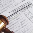 A gavel next to immigration forms related to the suspension of deportation applications. A gavel next to immigration forms related to the suspension of deportation applications.