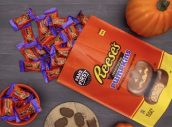 Reese's Halloween candy packaging featuring pumpkin-shaped chocolates with decorative designs.