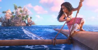 A scene from Disney's animated film *Moana*, featuring the main character navigating a boat on the ocean, with an island visible in the background.