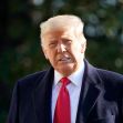Donald Trump standing outdoors, wearing a suit and tie, with trees in the background. Donald Trump standing outdoors, wearing a suit and tie, with trees in the background.