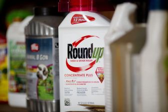 Image of a Roundup weed and grass killer bottle among other chemical containers.