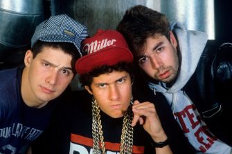 Iconic rap group posing in a retro style, featuring distinctive fashion and expressions.