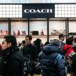 A crowded Coach store display featuring handbags and accessories. A crowded Coach store display featuring handbags and accessories.