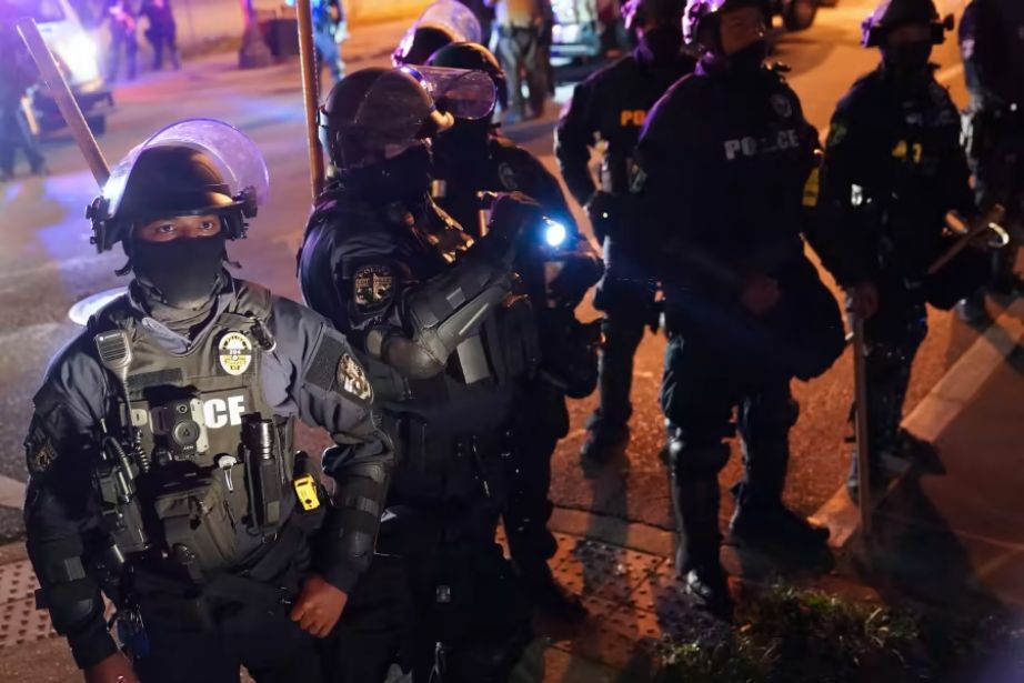 Sept. 24, 2020, file photo, police speak with protesters at the First Unitarian church, in Louisville, Ky. It could become a crime to taunt a police officer in Kentucky, under a bill that passed the state Senate on Thursday, March 11, 2021. (AP Photo/John Minchillo, File)