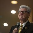 Former Mississippi Governor Phil Bryant speaking at an event, with a serious expression and microphone in hand. Former Mississippi Governor Phil Bryant speaking at an event, with a serious expression and microphone in hand.