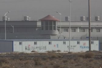 A detention facility surrounded by fencing and security features in Xinjiang, China, associated with allegations of forced labor and human rights abuses against Uighur Muslims.