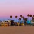 Venice, California beach scene at sunset with palm trees and colorful buildings. Venice, California beach scene at sunset with palm trees and colorful buildings.