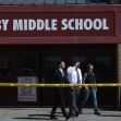Exterior view of Rigby Middle School with authorities present and police tape surrounding the area after a shooting incident. Exterior view of Rigby Middle School with authorities present and police tape surrounding the area after a shooting incident.
