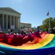 Demonstrators holding a large rainbow flag in front of the U.S. Supreme Court, advocating for LGBTQ+ rights. Demonstrators holding a large rainbow flag in front of the U.S. Supreme Court, advocating for LGBTQ+ rights.