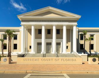 Exterior view of the Supreme Court of Florida building, showcasing its columns and front entrance.