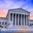 U.S. Supreme Court building at sunset, showcasing its architectural features. U.S. Supreme Court building at sunset, showcasing its architectural features.