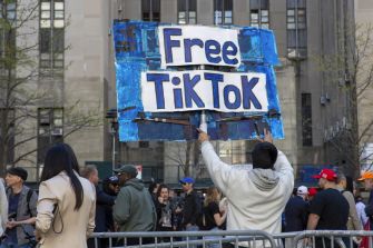 A demonstrator holds a sign reading "Free TikTok" at a rally in support of the platform amid concerns over a possible ban.