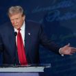 Former President Donald Trump speaking at a podium during a debate. Former President Donald Trump speaking at a podium during a debate.