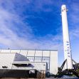 SpaceX facility with a Falcon 9 rocket in the foreground. SpaceX facility with a Falcon 9 rocket in the foreground.