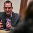 A man in a suit discusses topics related to anti-doping in sports during a meeting or conference. A man in a suit discusses topics related to anti-doping in sports during a meeting or conference.