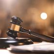 A wooden gavel resting on a sound block, symbolizing the judicial system and court rulings. A wooden gavel resting on a sound block, symbolizing the judicial system and court rulings.