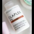 Olaplex No. 6 Bond Smoother hair product bottle on a surface. Olaplex No. 6 Bond Smoother hair product bottle on a surface.