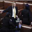 Representative Jim Jordan in a tense moment during a legislative session, surrounded by security personnel. Representative Jim Jordan in a tense moment during a legislative session, surrounded by security personnel.