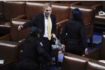 Representative Jim Jordan in a tense moment during a legislative session, surrounded by security personnel.