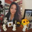 A memorial display honoring Stephanie Cosme, featuring photographs, flowers, and mementos. A memorial display honoring Stephanie Cosme, featuring photographs, flowers, and mementos.